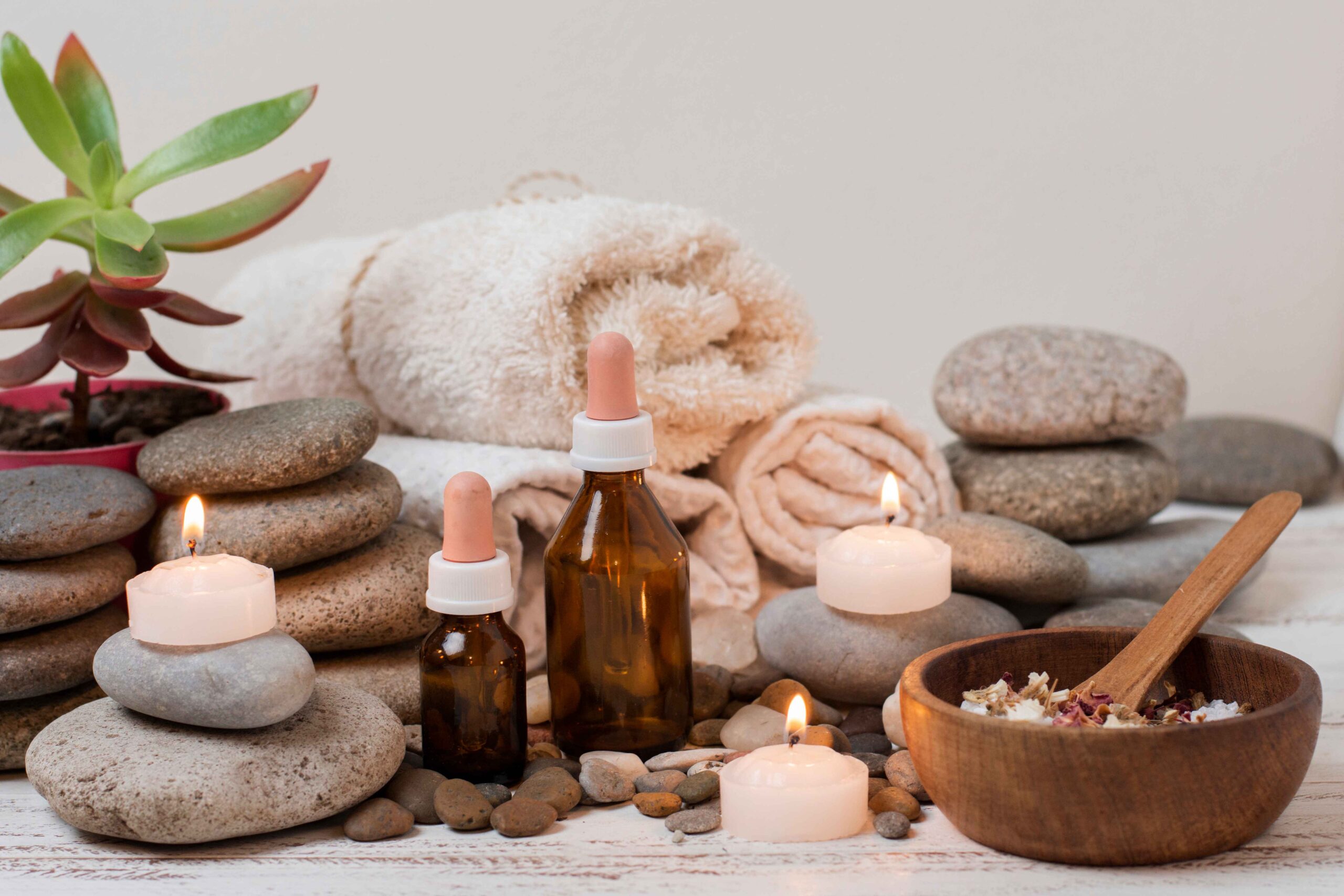 arrangement with spa stones lit candles_11zon scaled