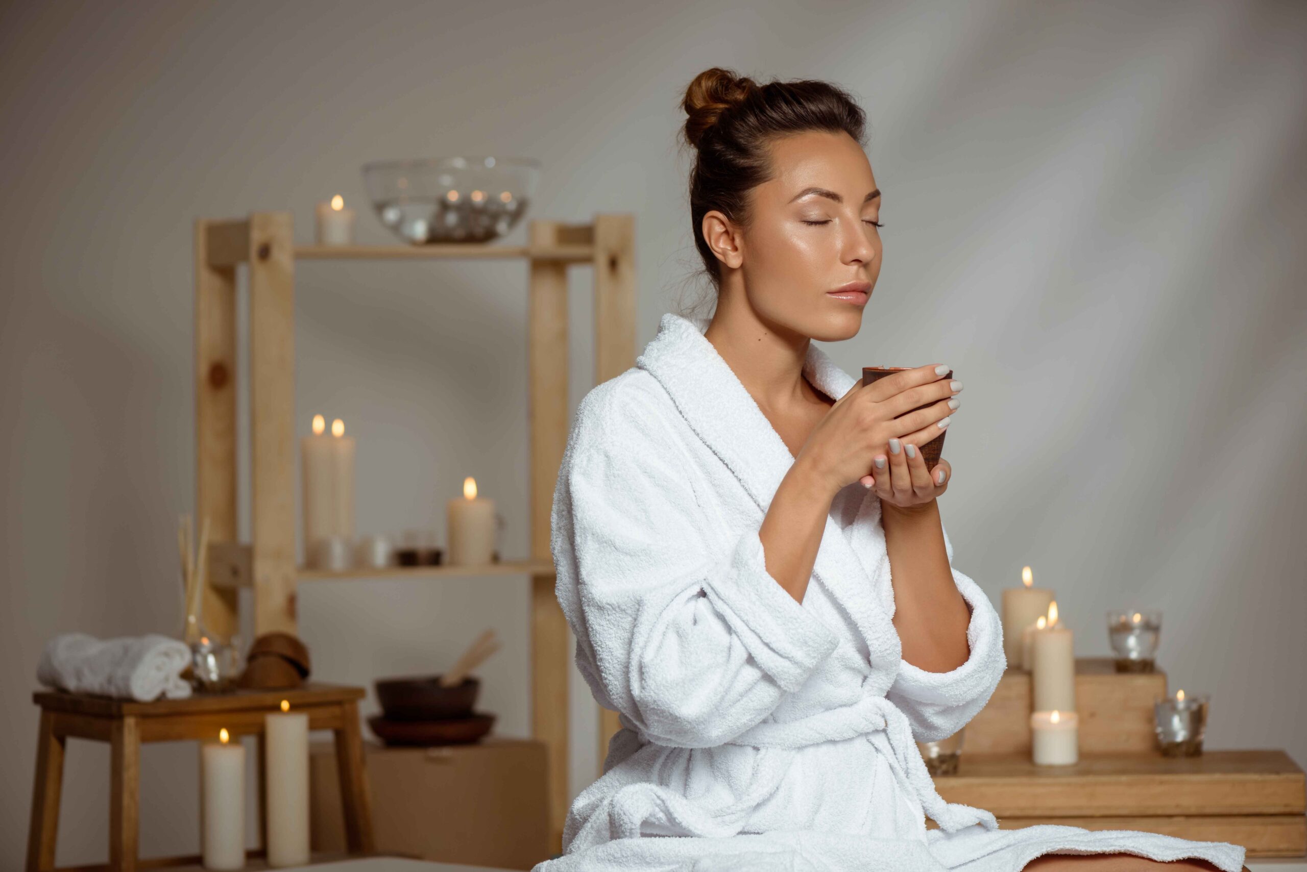 young woman holding tea cup relaxing spa salon_11zon scaled